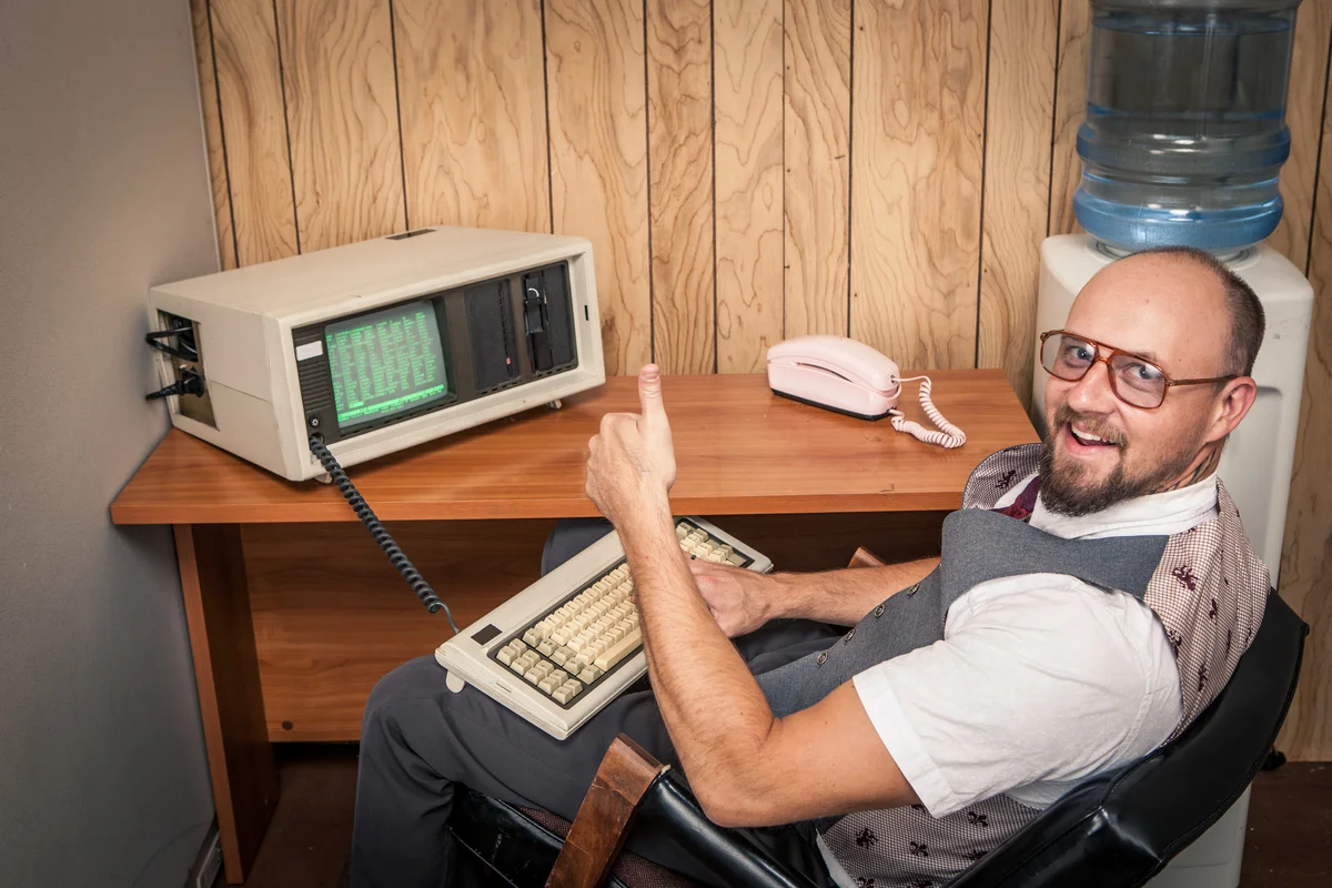 Man using an early 1980s computer