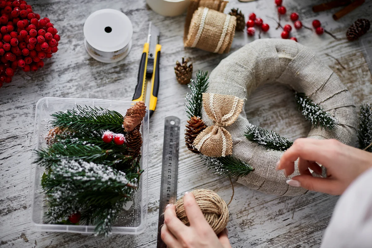 Close-up of craftswoman making Advent wreath