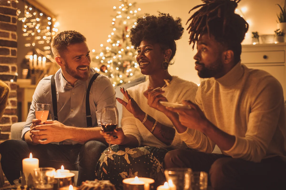Group of friends having a party at home. Sitting on sofa