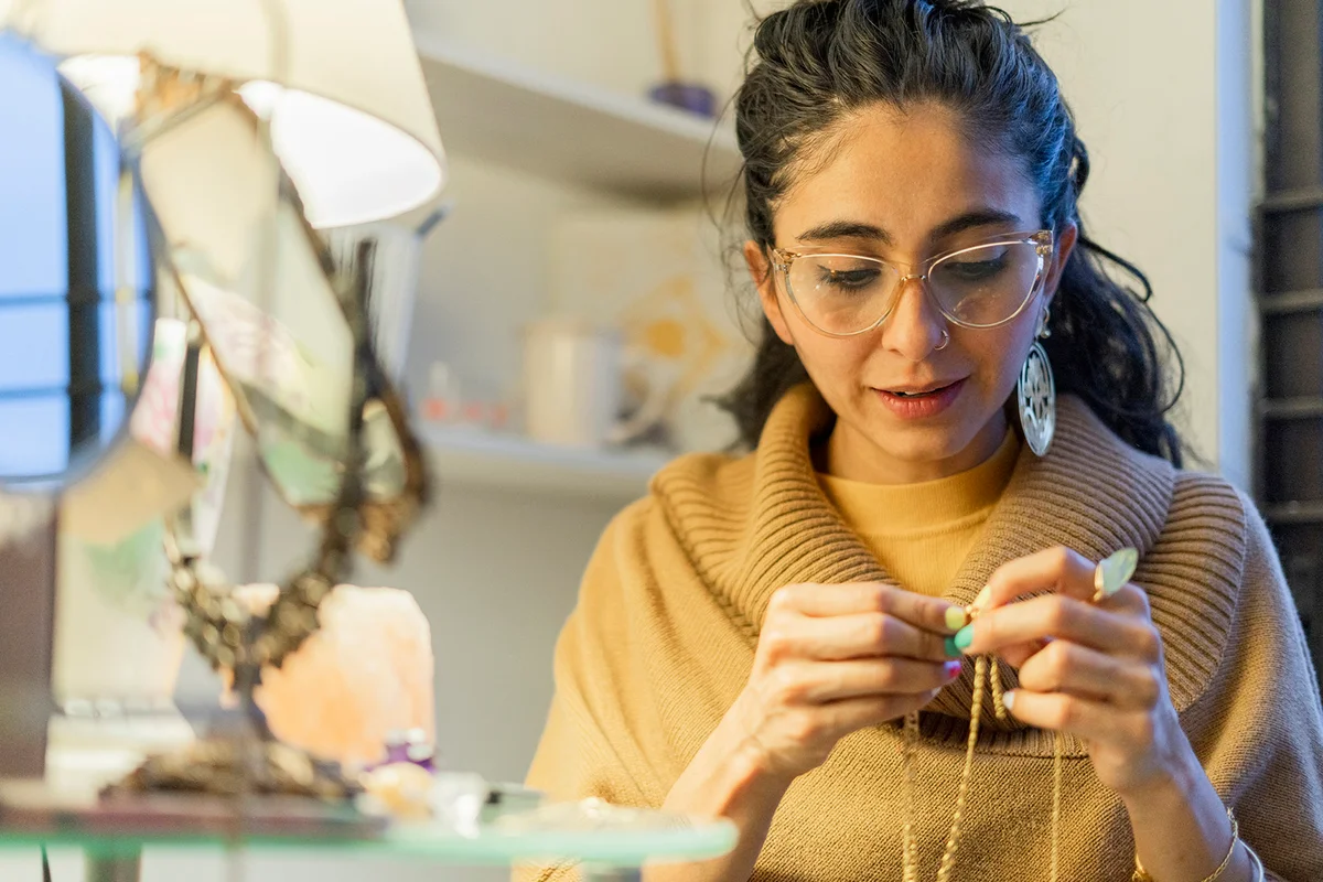 woman creates necklaces with beautiful stones