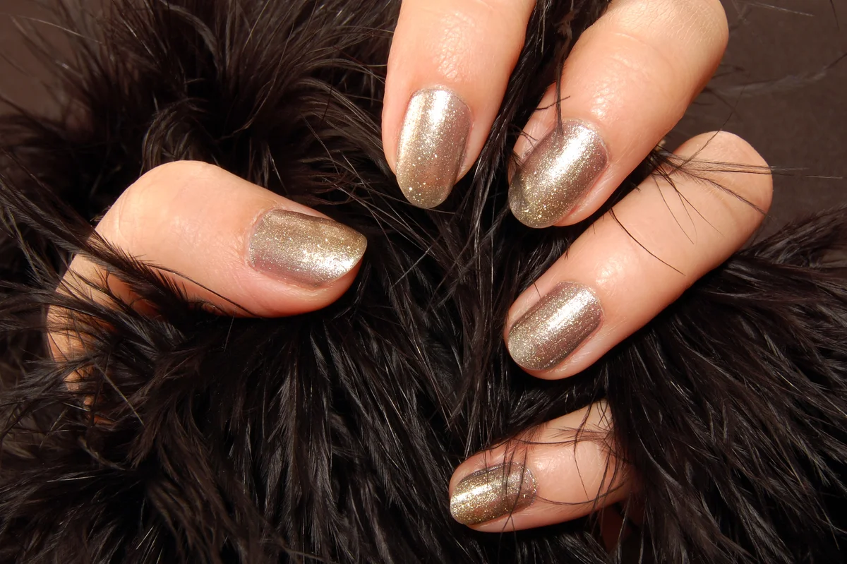 Female hand with nail polish holds fur
