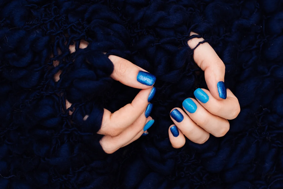 Female hands with blue nails