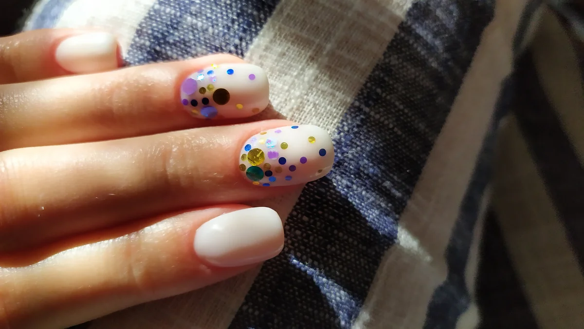 Close-Up Of Woman Fingers With Nail Art Manicure white nails