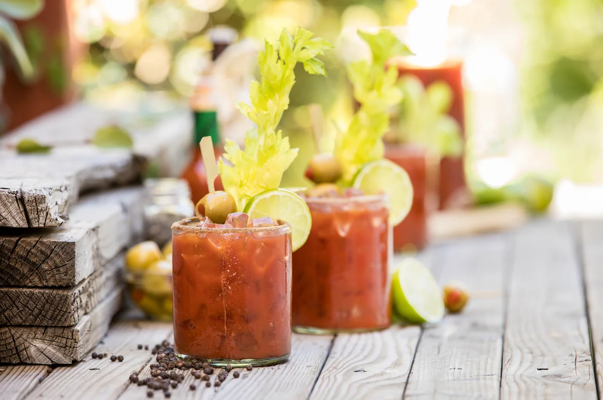 Group of bloody mary's on an outside table ready for a party