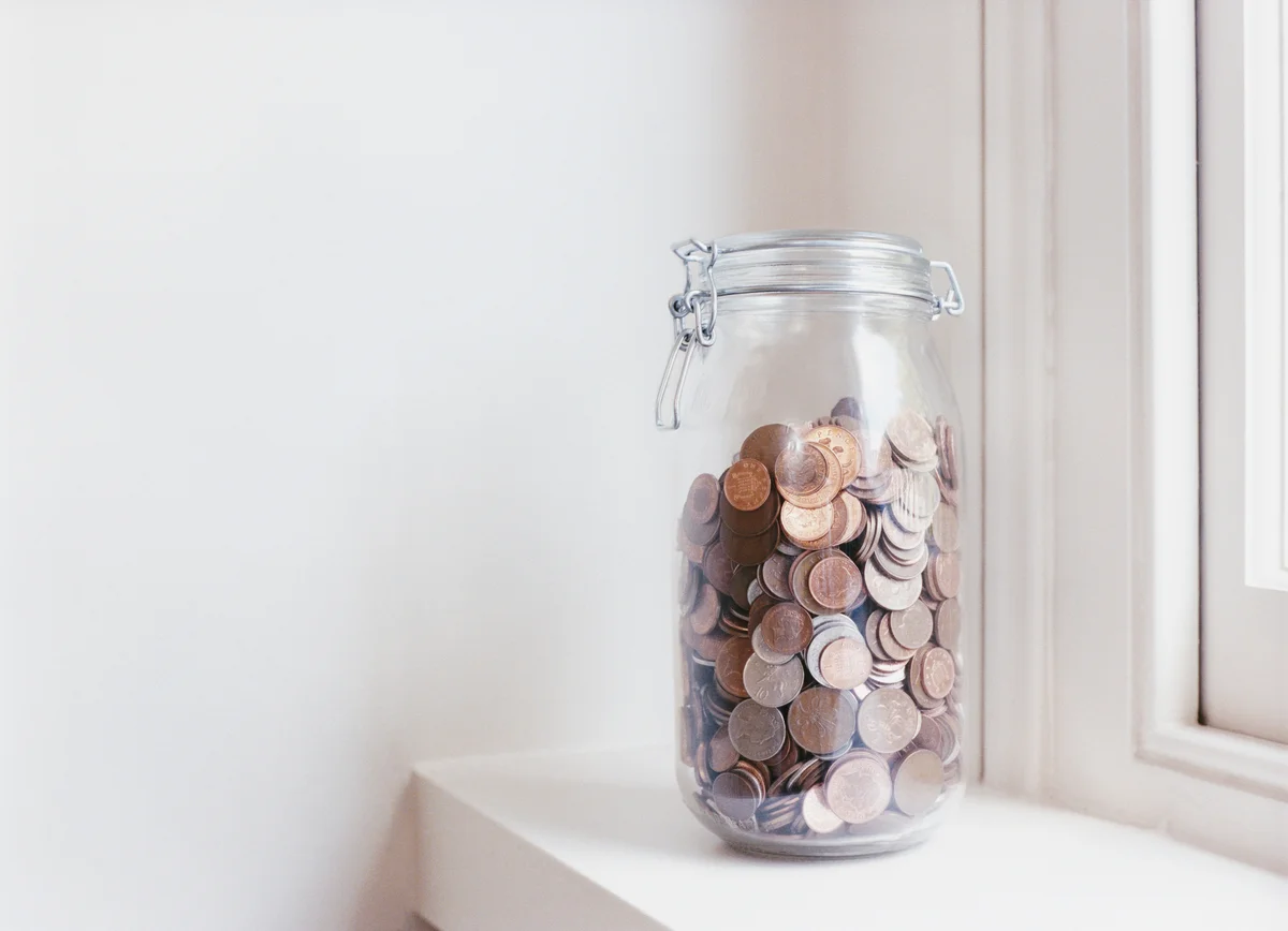 Jar of coins on windowsill