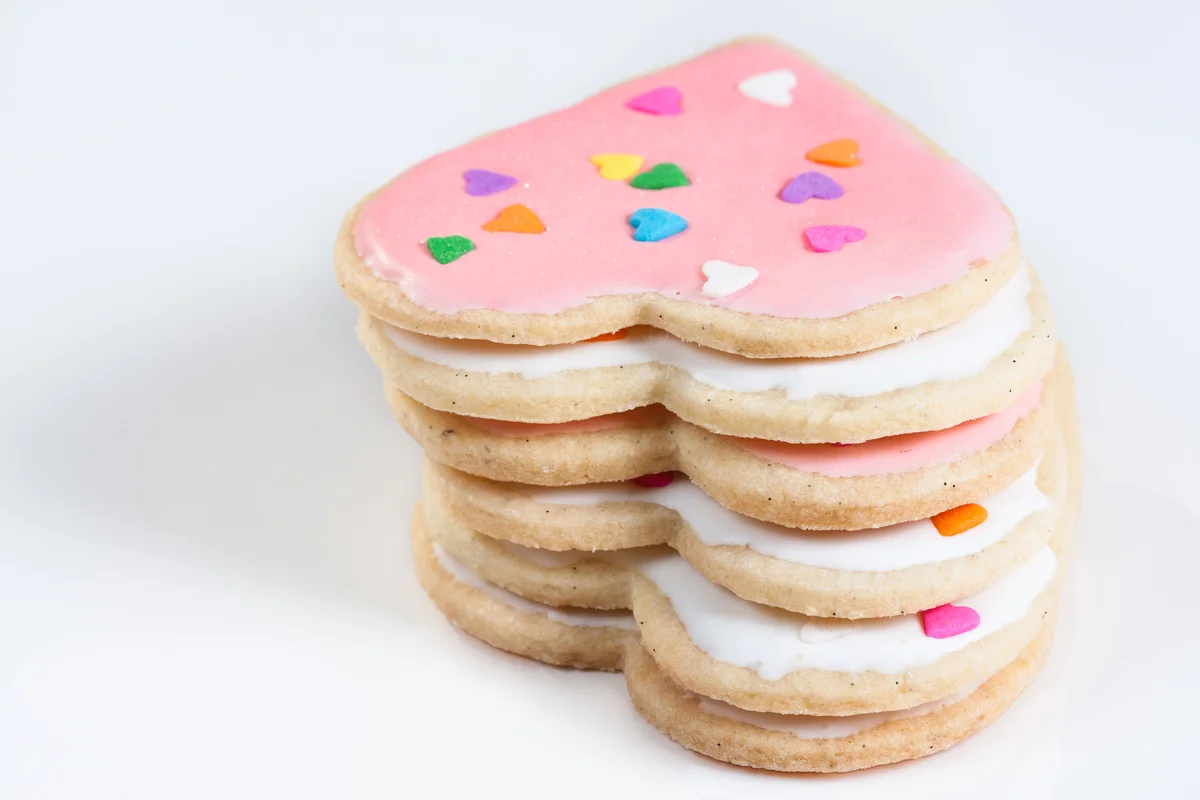 rolled hear-shaped sugar cookies with pink icing
