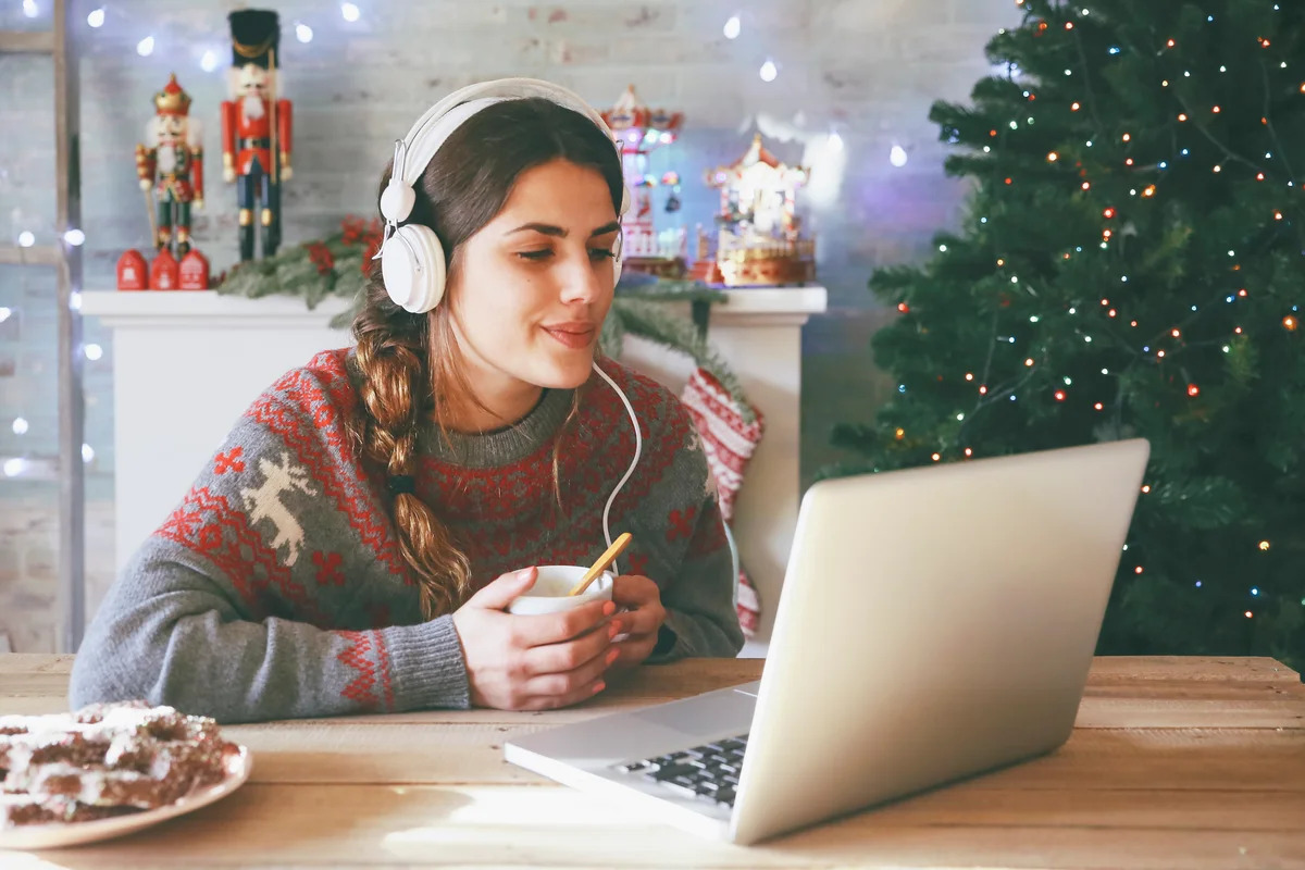 woman listening to music on her laptop at Christmas