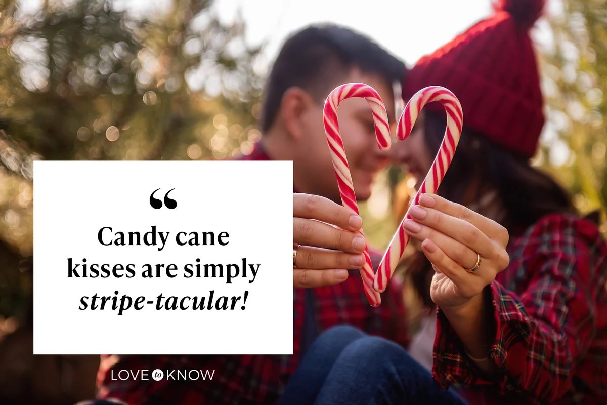 Couple kissing and making an heart with candy cane