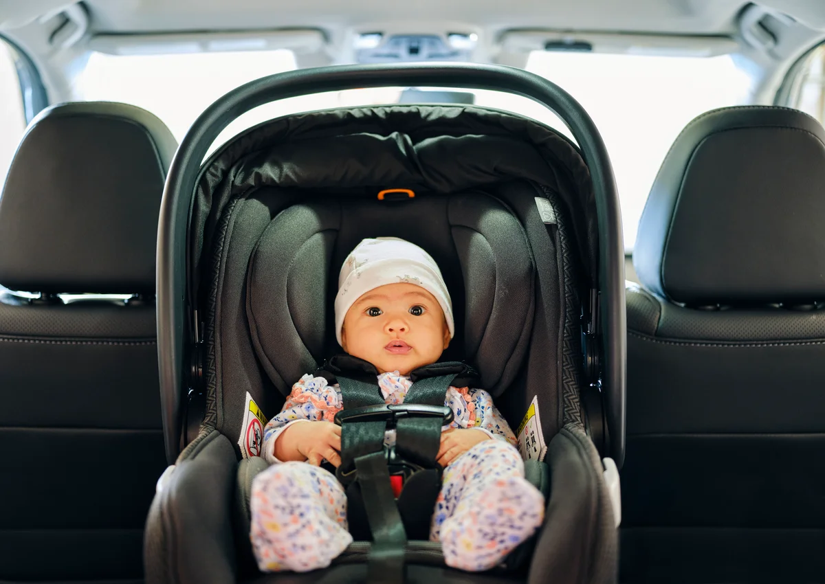 baby in winter in car seat