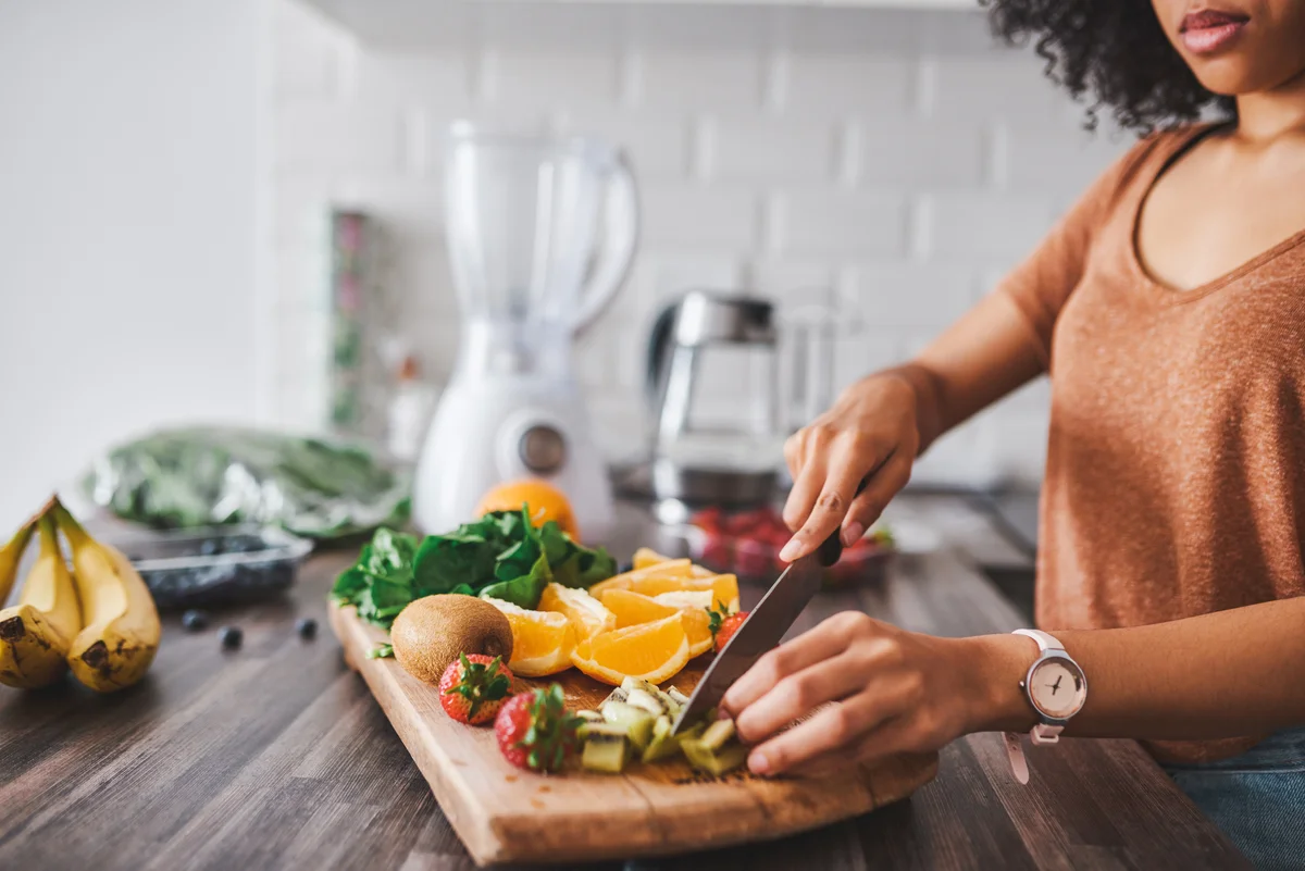 woman chopping fruit