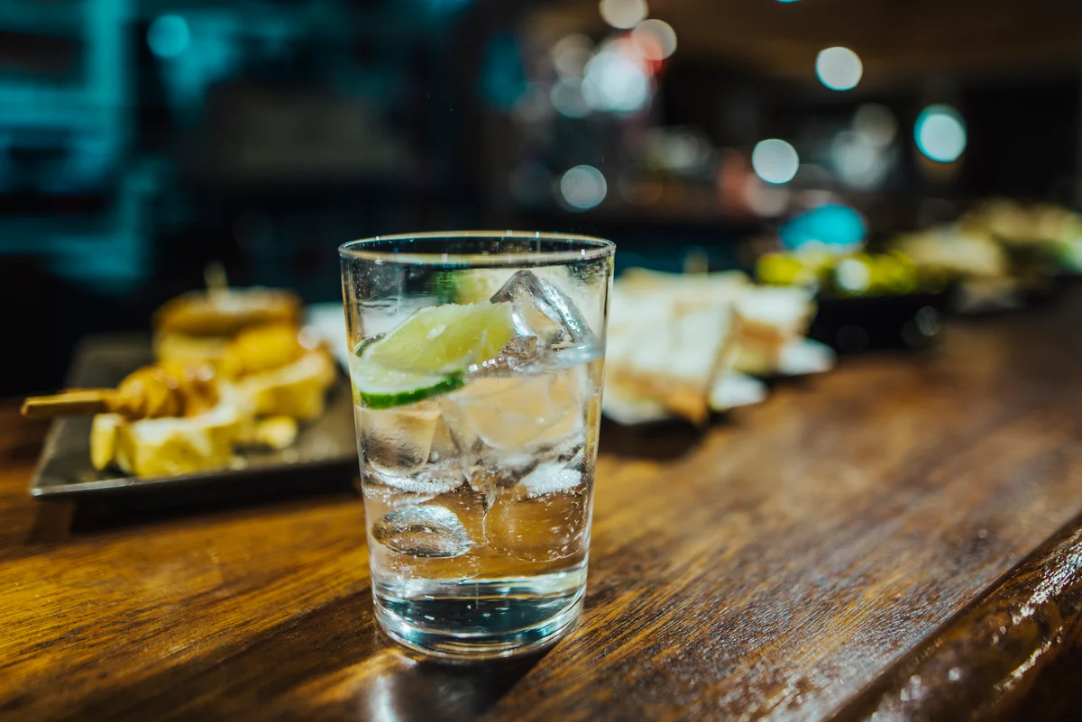clear drink on a bar