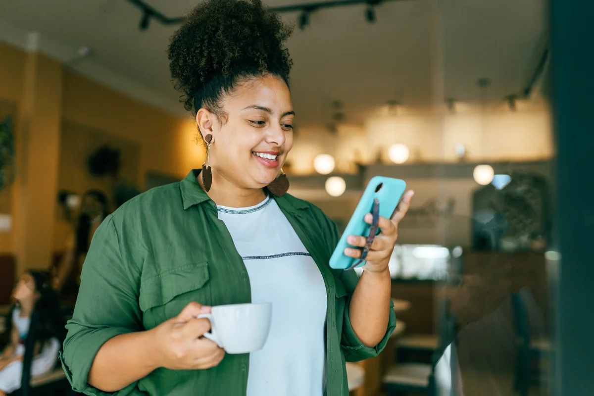 Woman in green using smartphone