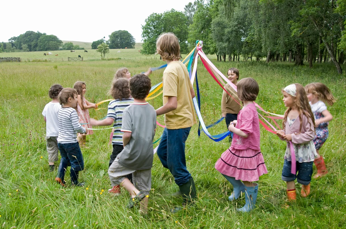 kids dancing around a maypole