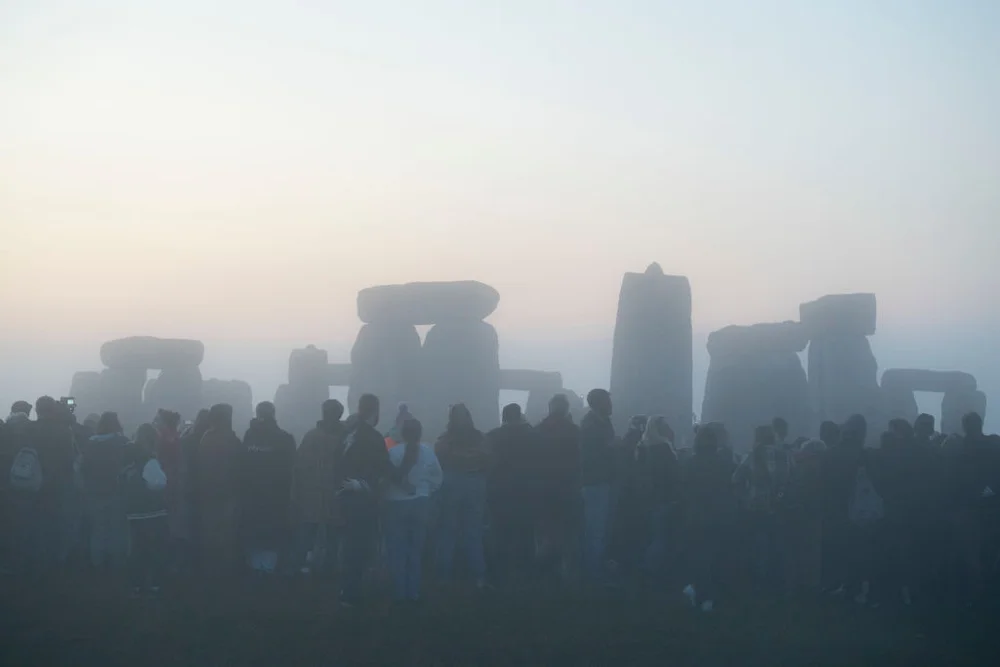 Spiritually-minded revellers await sunrise at dawn during the summer Solstice (mid-summer and longest day) at the ancient late-Neolithic stones of Stonehenge, on 21st June 2023, in Wiltshire, England. The summer solstice is the northern hemisphere's longest day and shortest night of the year, when the earth's axis is tilted at its closest point from the sun and pagans say the ancient monument is a sacred place that links the Earth, Moon, Sun and the seasons. Stonehenge was built in three phases between 3,000 B.C. and 1,600 B.C. Stonehenge is owned by English Heritage who say 8,000 visitors were allowed into the ancient site for the 2023 solstice sunrise.