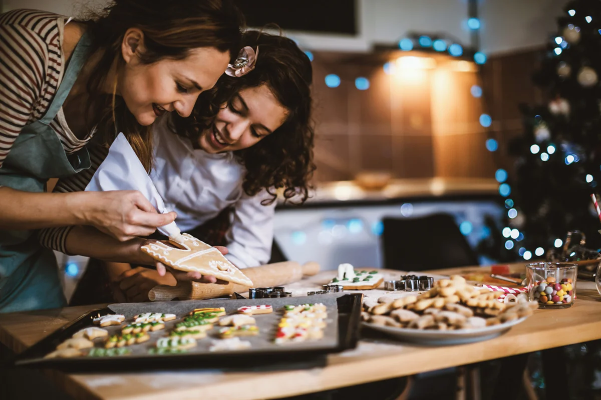 Mother and daughter making Gingerbread cookies for Christmas