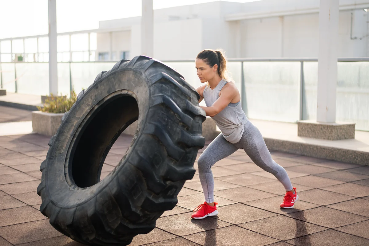 woman working out with a tire