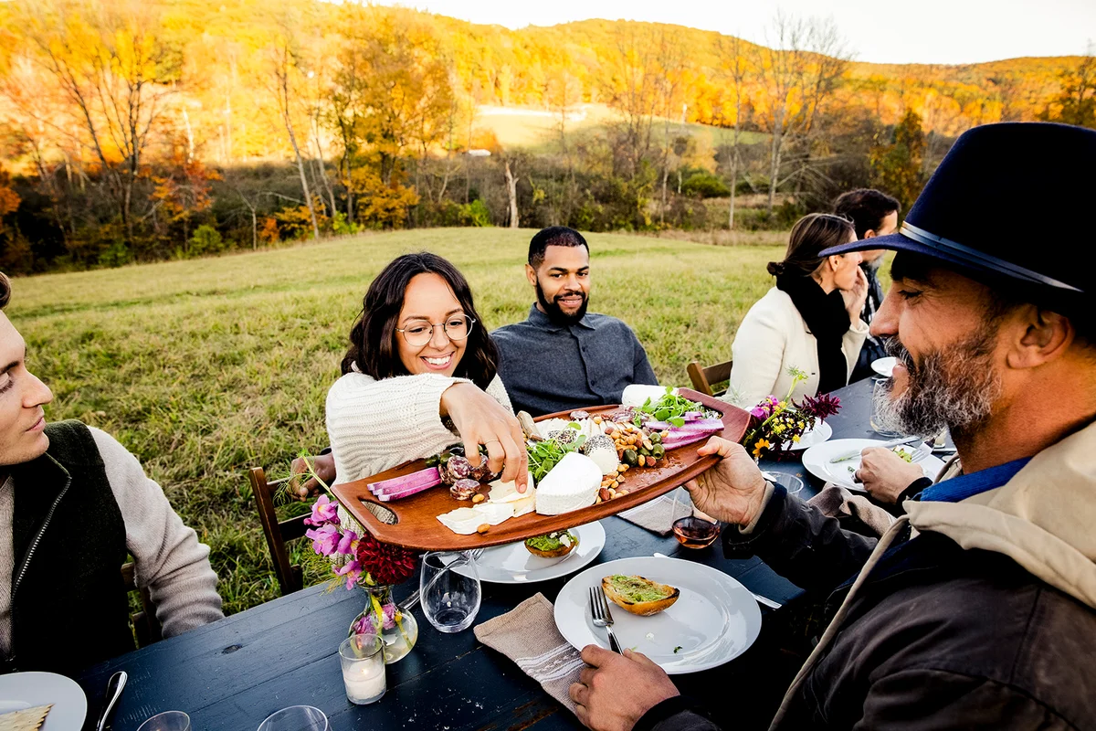 Friends sharing food during outdoor dinner party