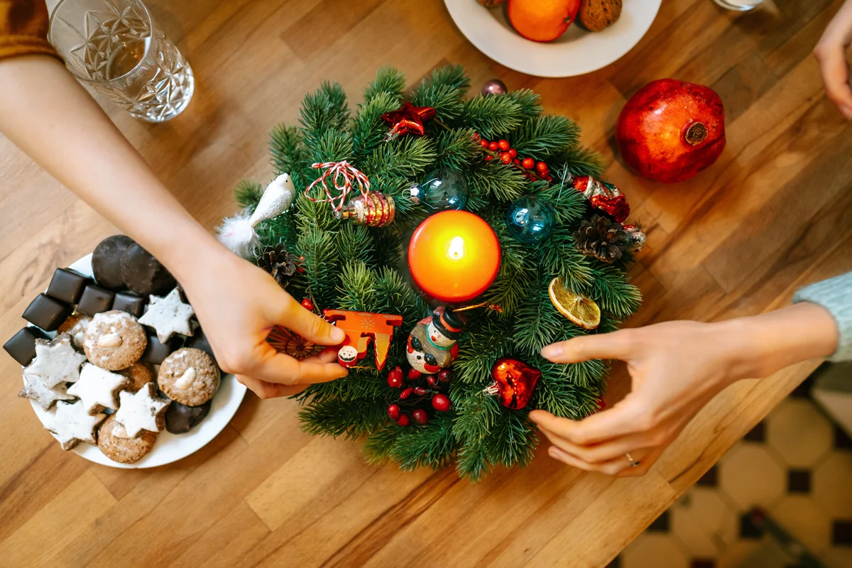 Christmas table with hands and advent wreath