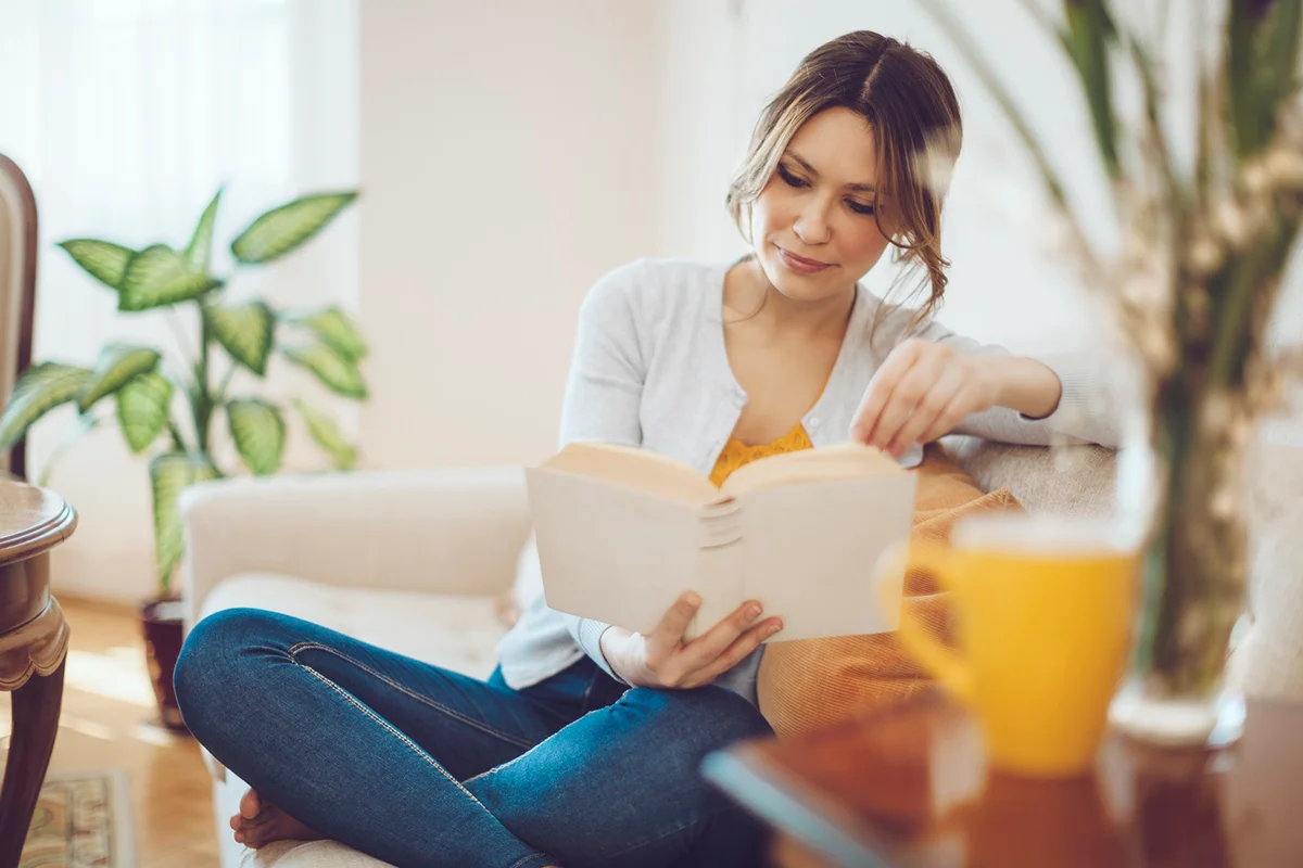 woman reading a book at home
