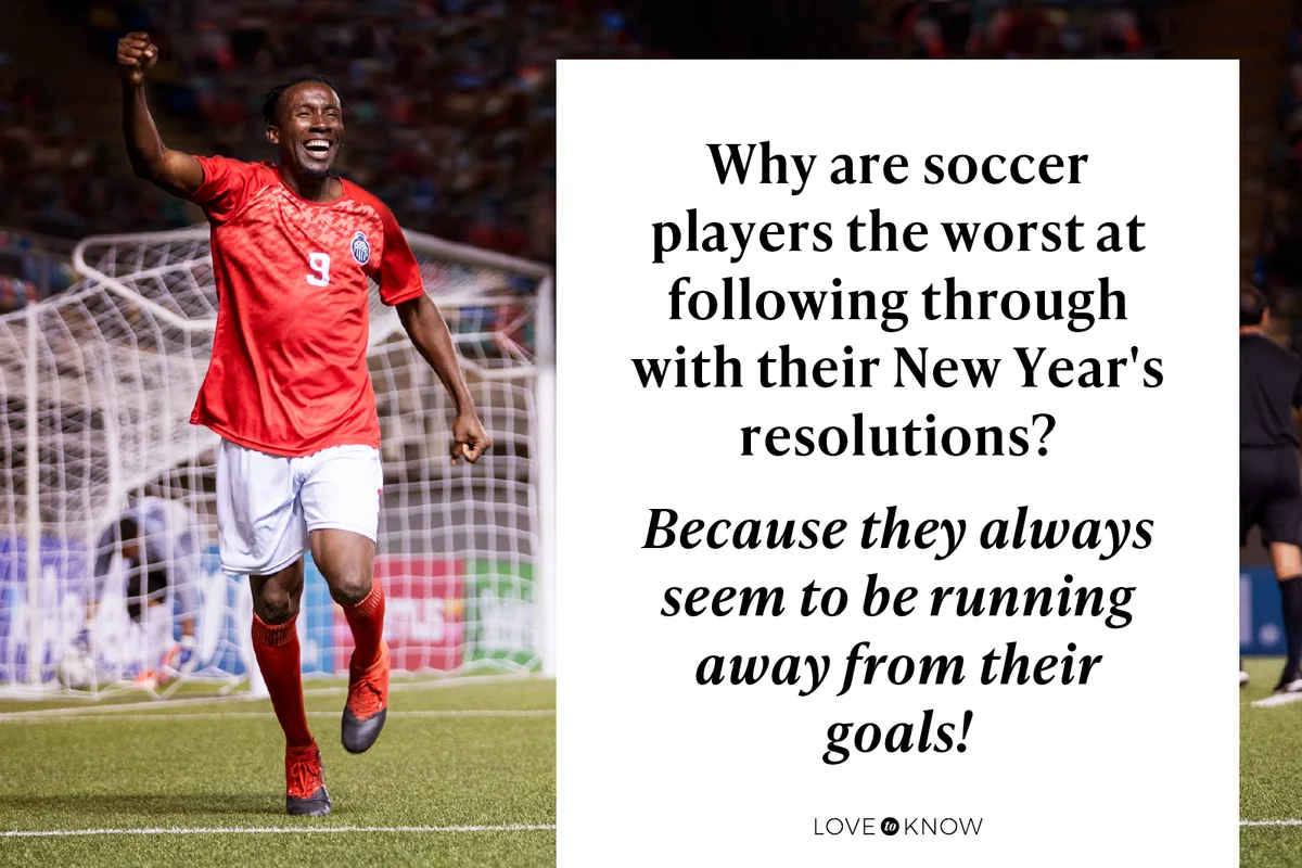 Professional football striker runs across the pitch celebrating scoring a goal