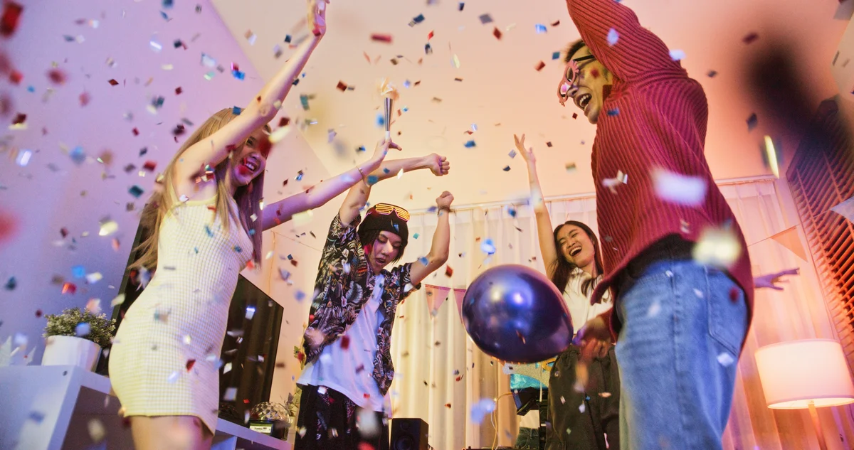 friends at a party with confetti & balloons