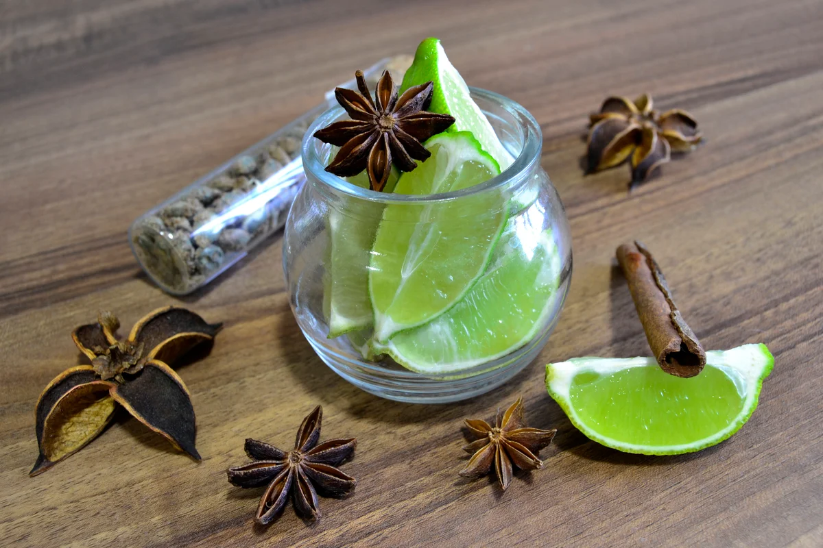 Close-up of sliced lime in crystal glass with star anise