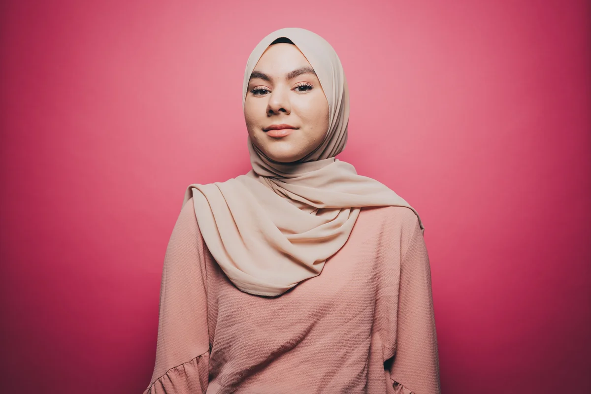 young woman against pink background