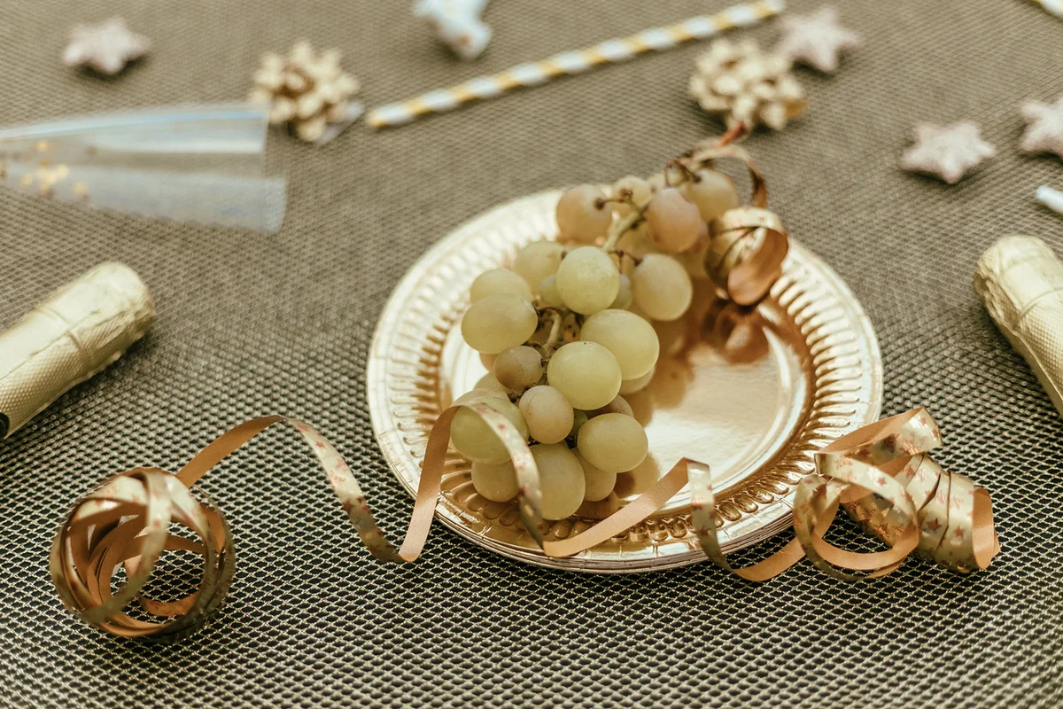 Spanish New Year traditional. Funny ritual to eat twelve 12 grapes for good luck at midnigth