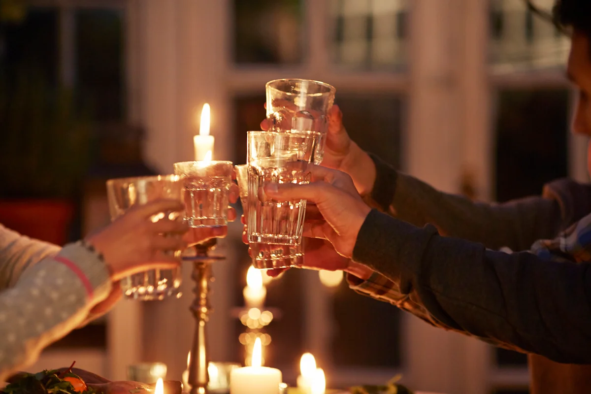 Family toasting at dinner with candle lights