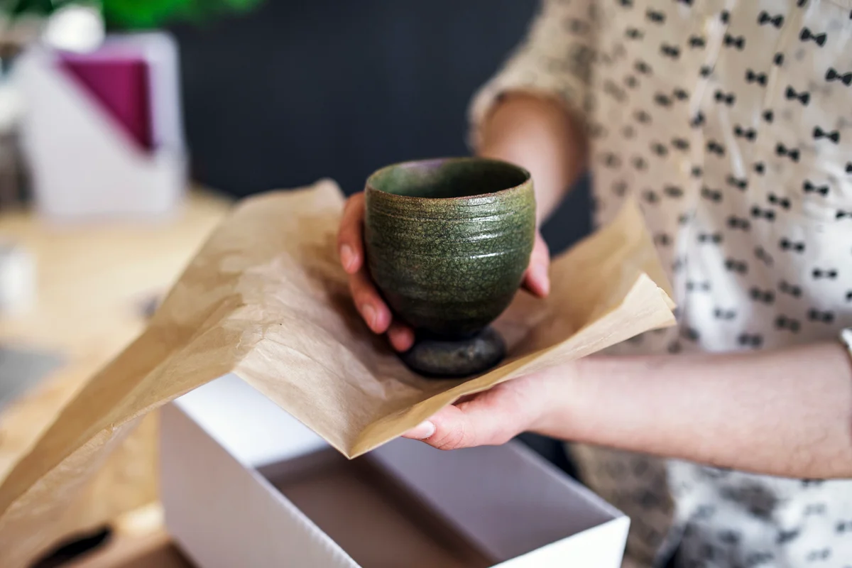 Woman packing pottery
