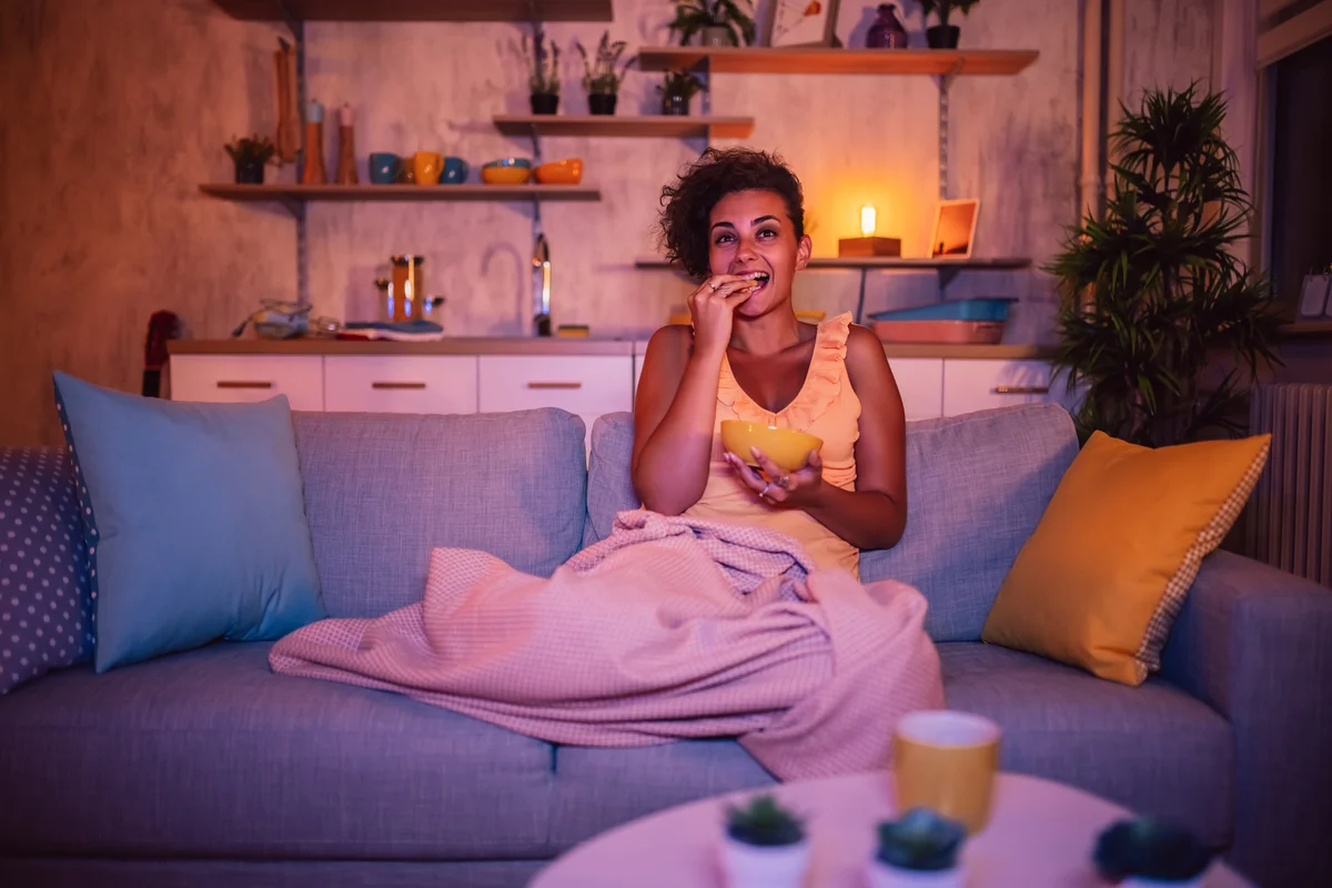 woman watching show late at night