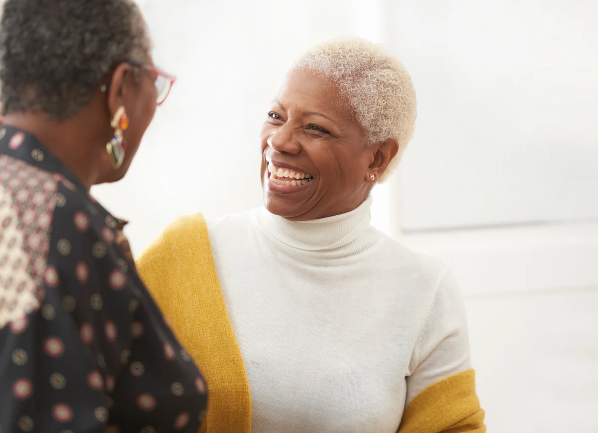 Senior women smiling and talking to friend