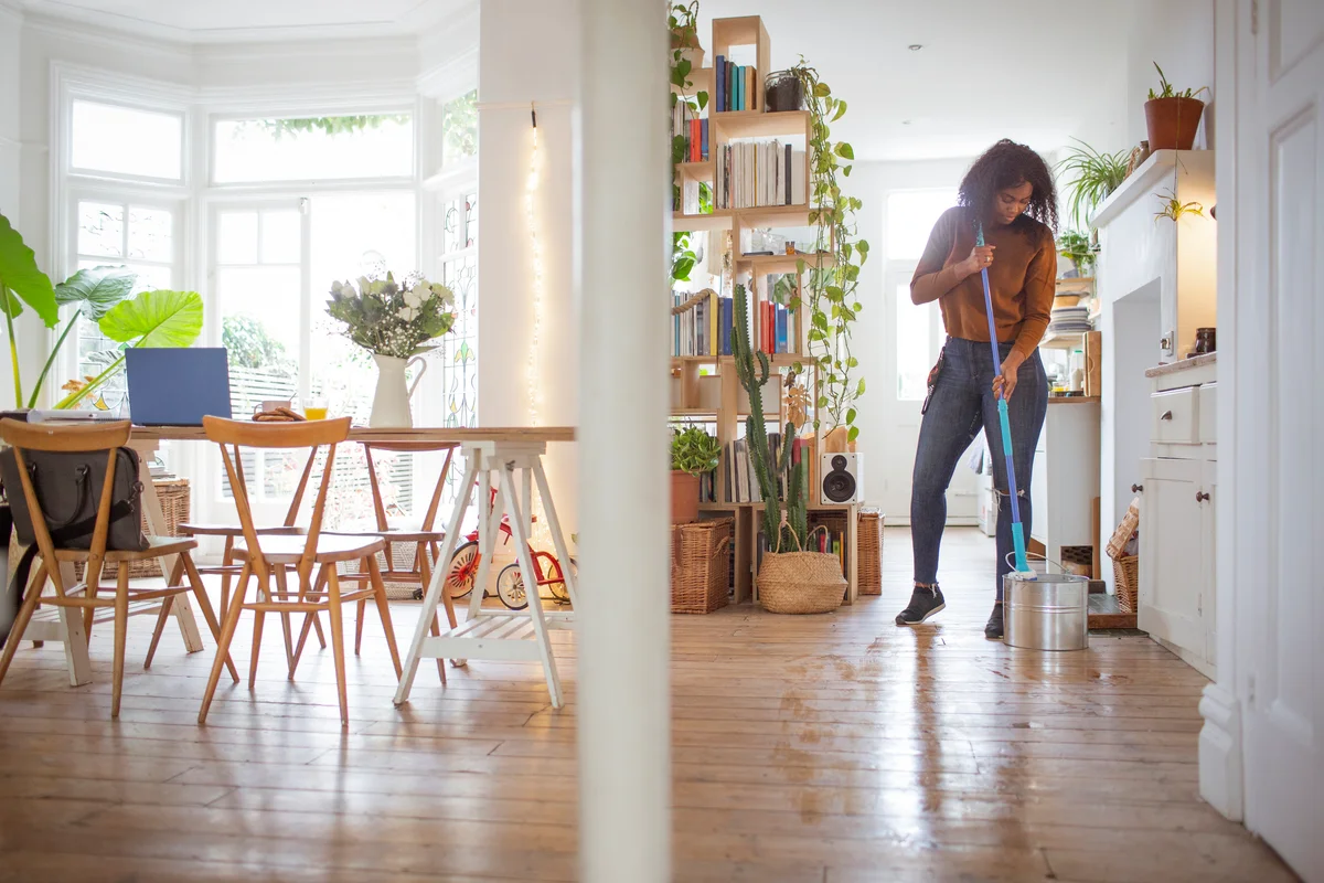 woman mopping a hardwood flor