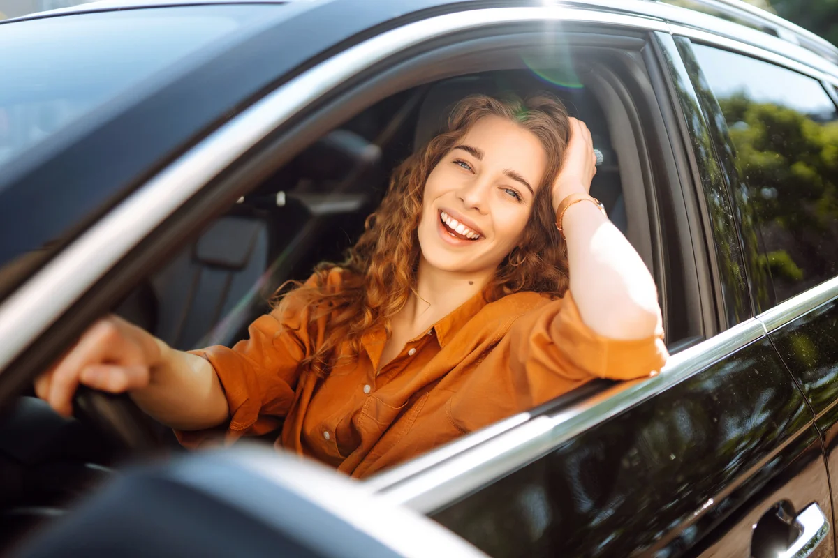 Smiling woman driving a car