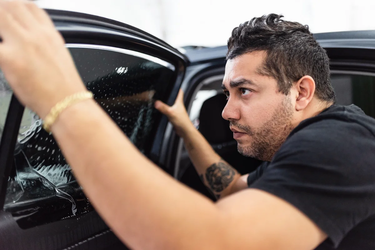 Man applying car window film