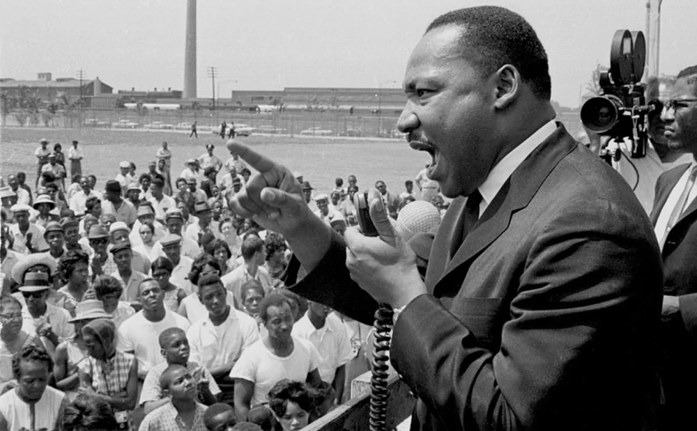 American Civil Rights leader Dr. Martin Luther King Jr. (1929 - 1968) speaks at a rally held at the Robert Taylor Houses in Chicago, Illinois, 1960s