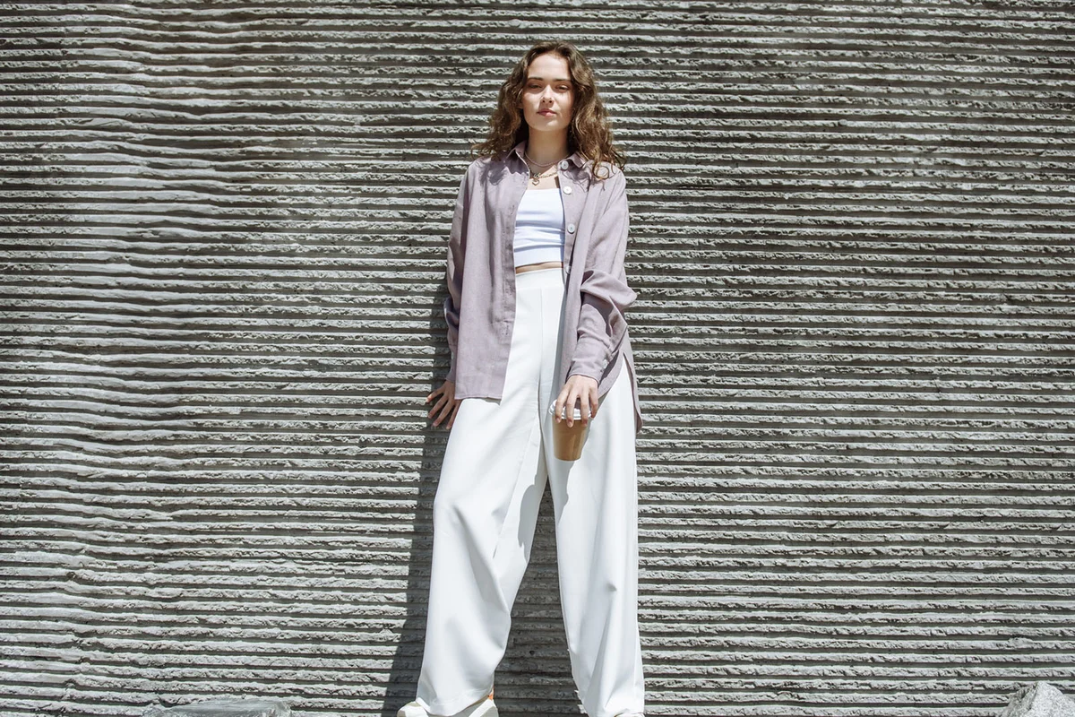 Young brunette woman in fashionable modern clothes