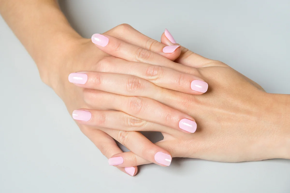Pair of elegant hands with pink nail paint