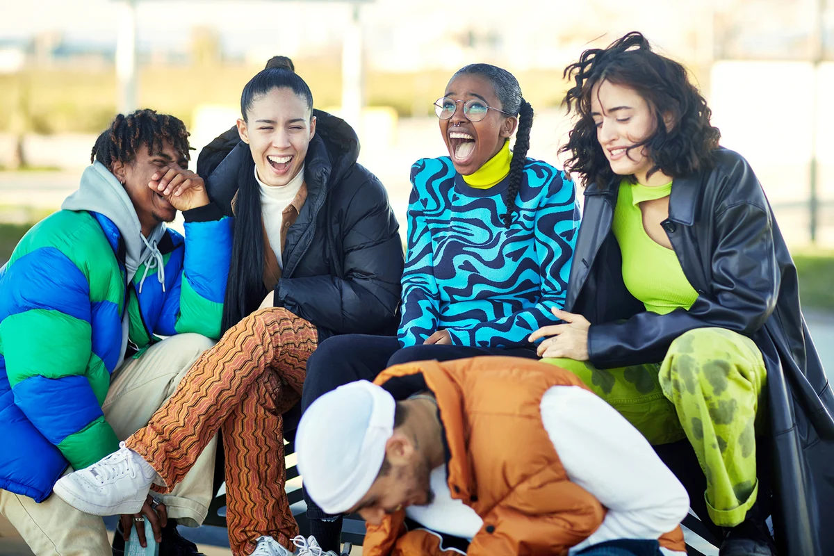 Young Barcelona friends talking and laughing outdoors