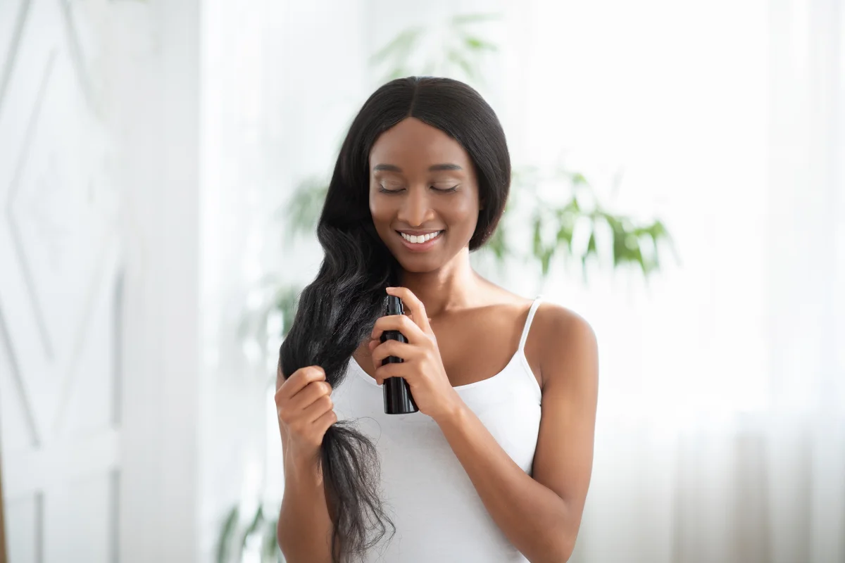 applying leave-in conditioner to relaxed hair