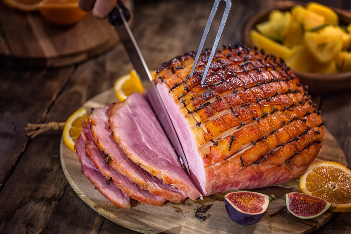 carving a clove-studded ham