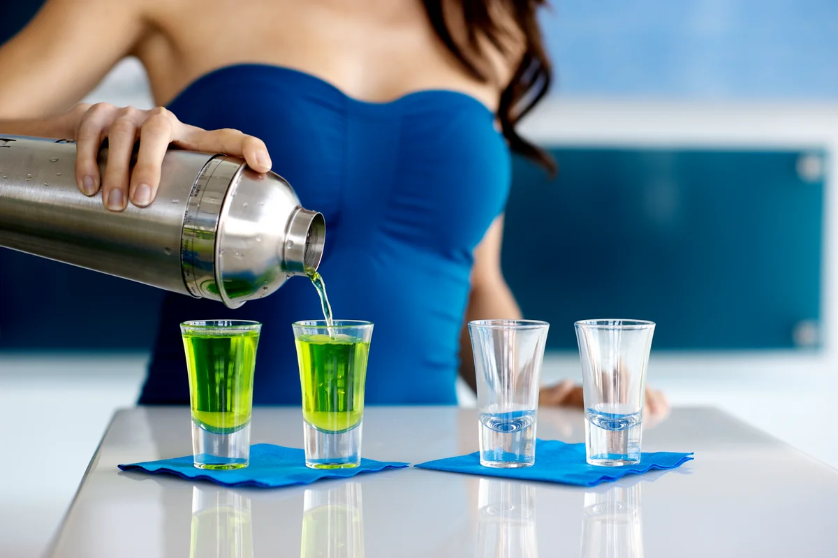 bartender pouring midori shots