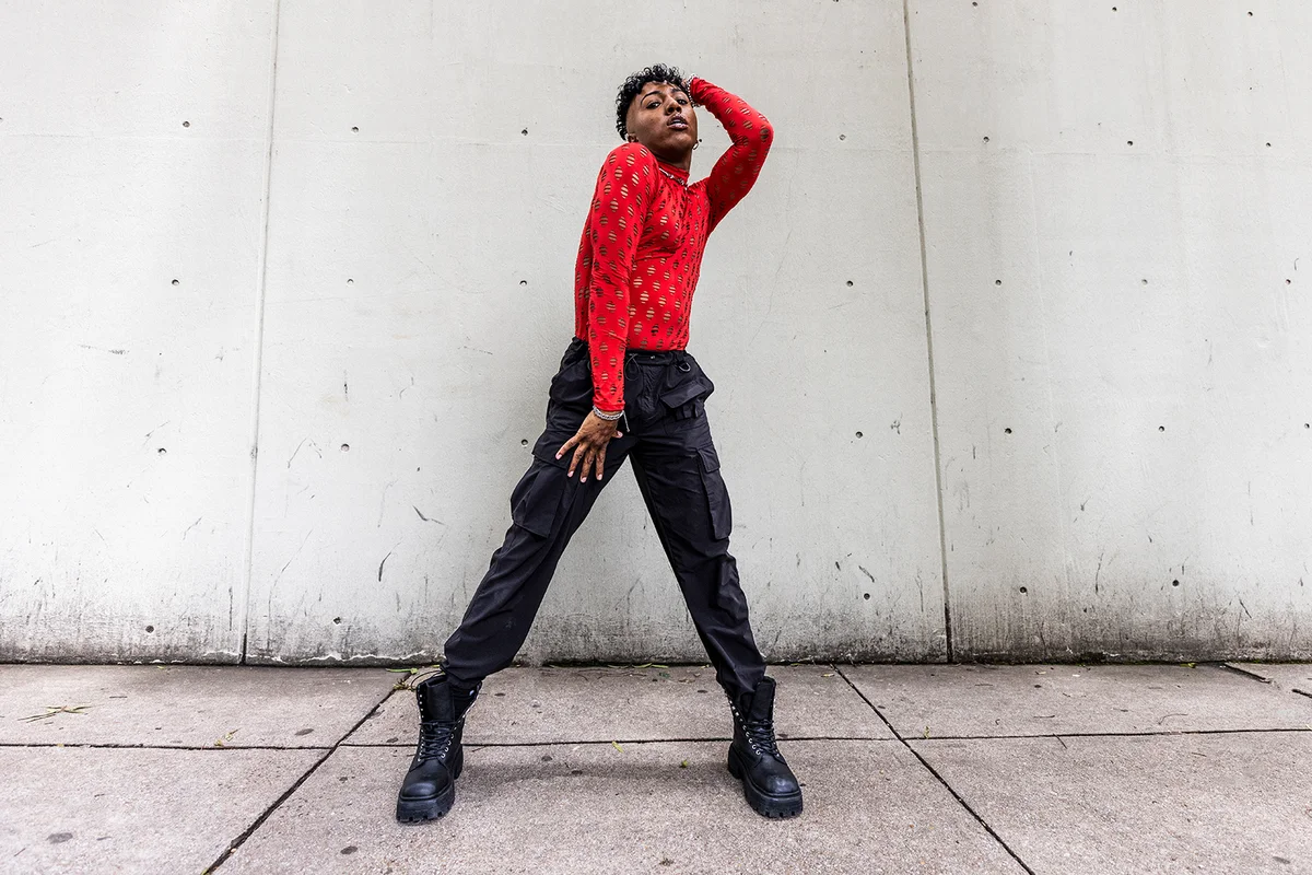 Fashionable male professional dancer on urban sidewalk