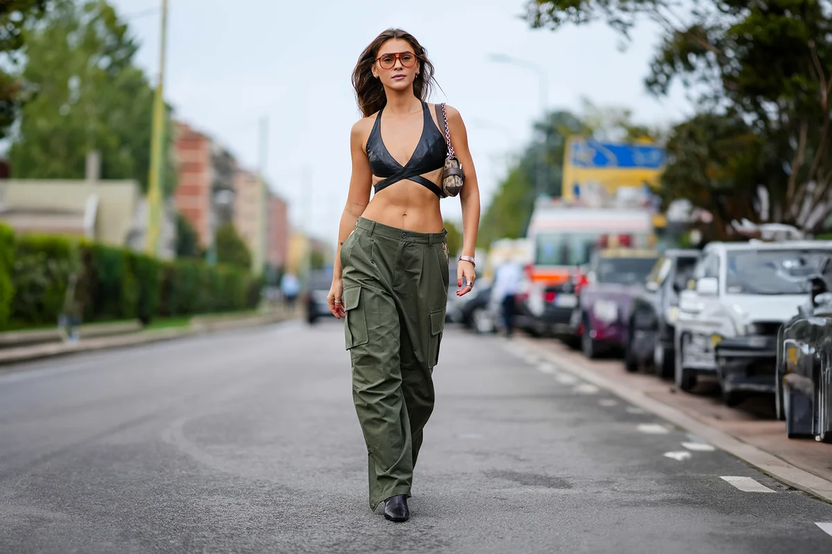 black leather bras, a brown Gucci logo bag, green cargo pants