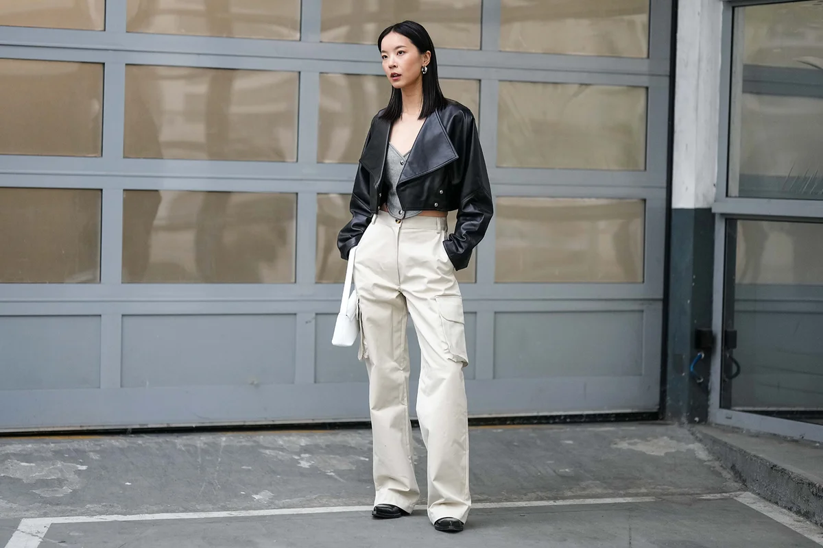 black shiny leather cropped jacket, high waist white latte cargo pants