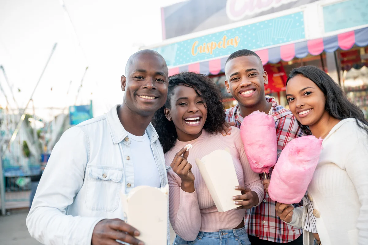 dad and kids at an amusement park