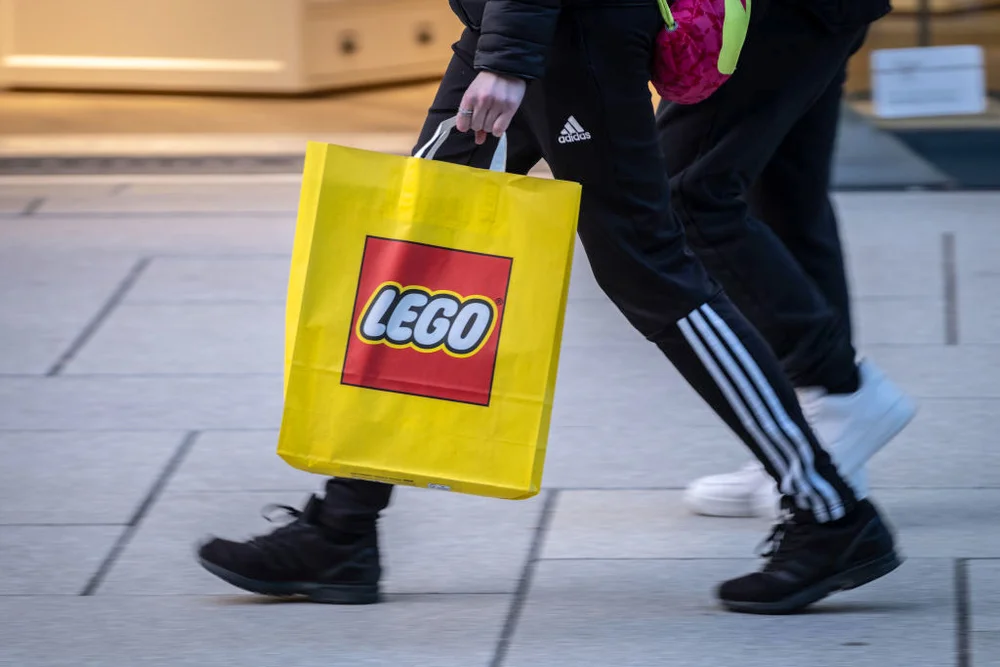 Woman carrying a Lego bag
