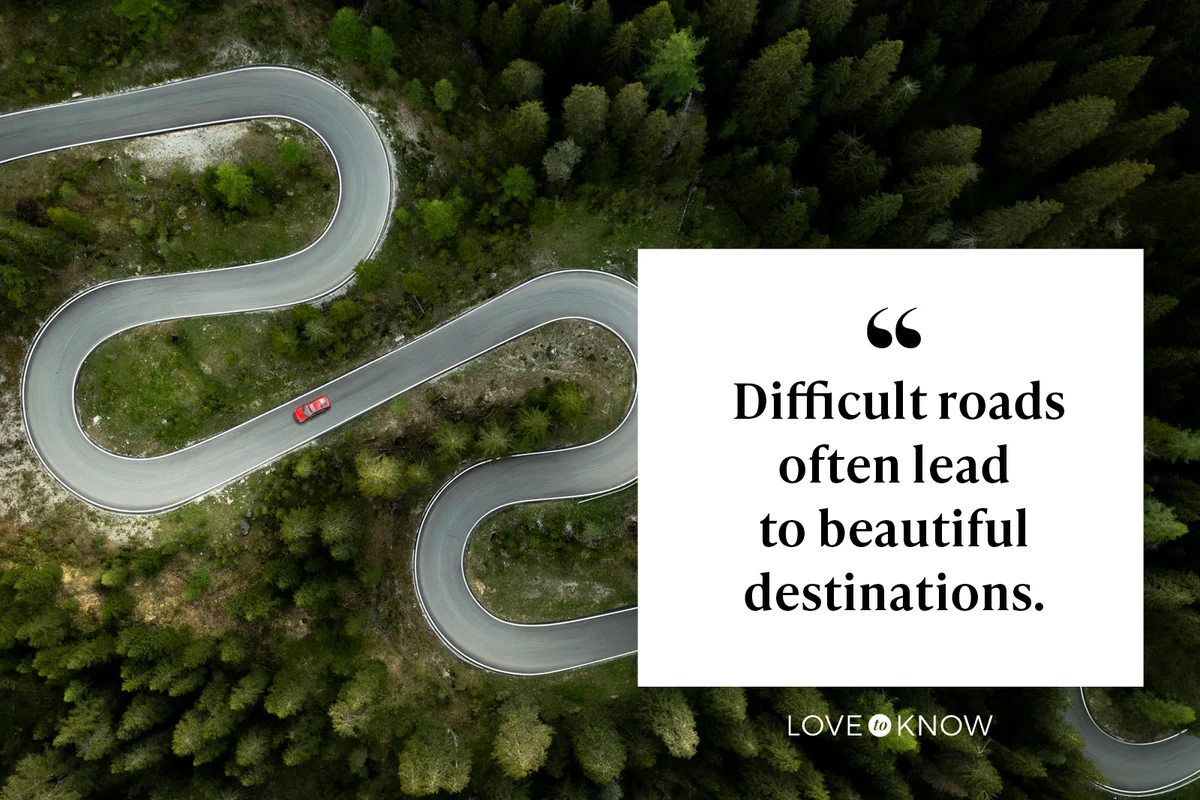 Car traveling on winding mountain road in a forest