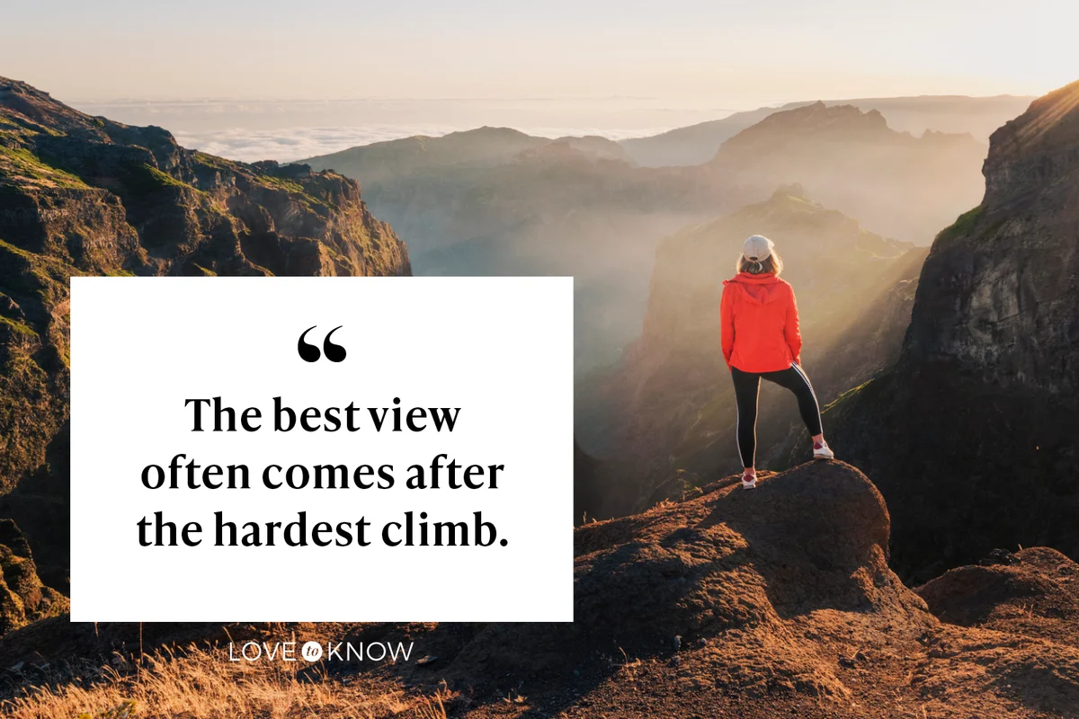 Woman admiring the sunset from the top of a mountain