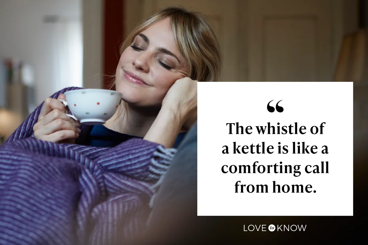 Smiling woman with cup of tea relaxing on couch at home